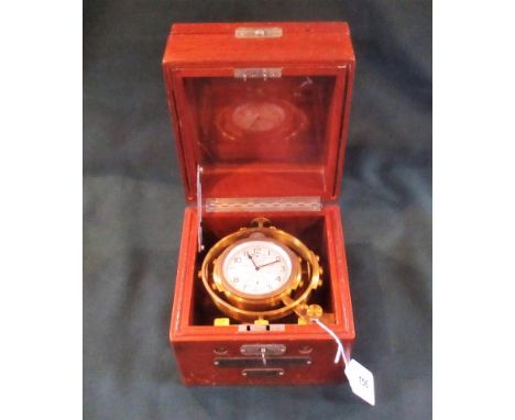 A Hamilton model 22, two day deck chronometer, circa 1942 in a Gimballed brass frame and mahogany case.   Condition Report:  