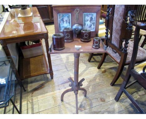 An Edwardian parlour game, the oak super structure containing two period portrait prints of young ladies, above a galleried s
