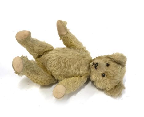 A Steiff style teddy bear with rotating head operated by tail, 35cmL 