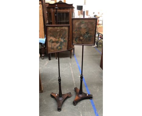 A pair of 19th century rosewood pole firescreens, one with finial missing, each on a triform base with floral painted velvet 