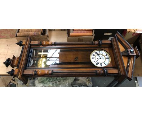 A regulator wall clock, architectural pediment, enamel dial with Roman numerals, flanked by columns, 130cmL 