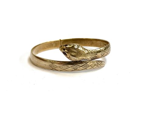 A gold plated silver snake bangle with garnet eyes, hallmarked for London, 1965, 25.8g 