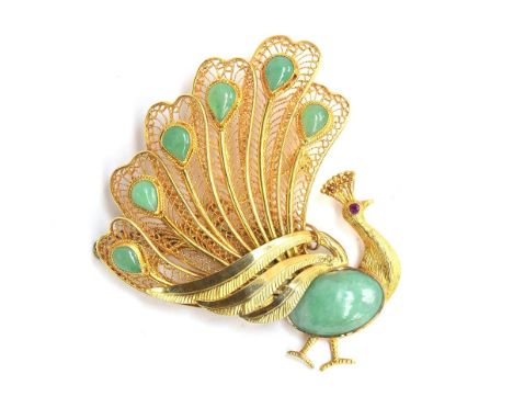 A 20th century Chinese 14ct gold peacock brooch, set with jade cabochons and a ruby eye, with safety chain, 5.5cm long, appro