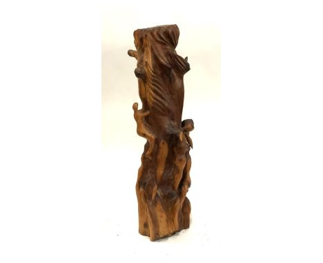 A carved yew wood sculpture of figures climbing a tree trunk (af), 72cmH 