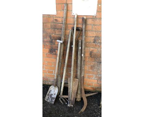 A quantity of vintage tools to include spade, pickaxe, etc 