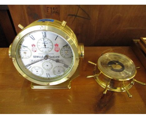 A Sewills sealed chronometer works, together with a small barometer in the form of a ship's wheel 