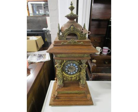 A French oak cased mantel clock, 3 1/8" gilt brass and enamelled dial with Roman numerals, gilt metal mounts and figural colu