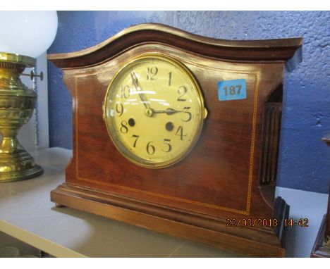 An Edwardian mahogany mantel clock with an ached top and inlay details, 13 1/2" x 9" 