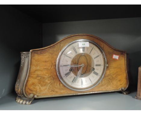 A mantle clock with burr veneer front and chime