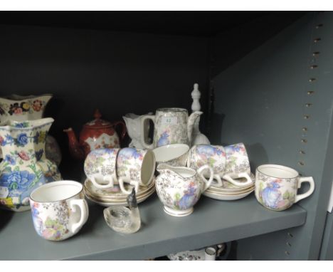A part tea service in fine bone china with print and gold decal etc