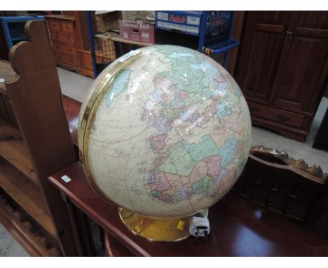 A globe of the world with cream sea and brass base