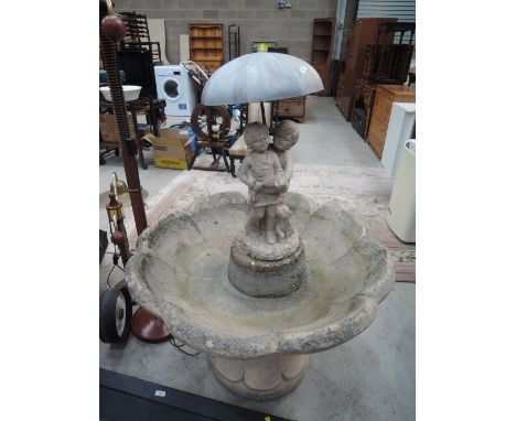 A large heavy concrete cast garden planter or fountain base
