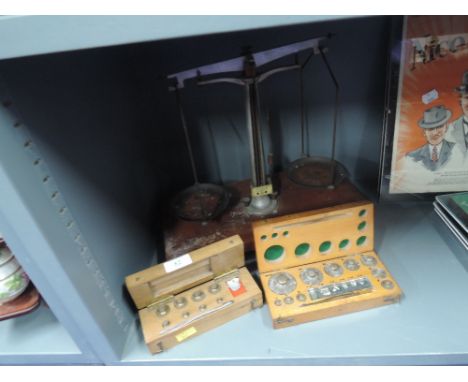 A set of fine chemist or apothecary balance scales with two weight sets complete