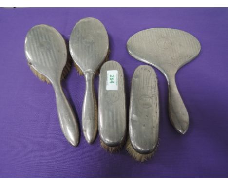 A five piece silver dressing table set having engine turned striped decoration and monogrammed M to cartouche, Birmingham 192