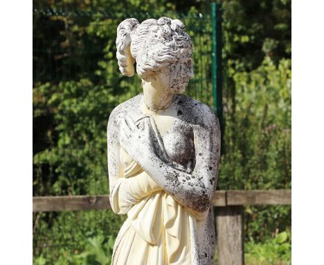 A composite stone garden statue of a classical maiden,depicted with her arms crossed, raised on a plinth,total 157cm highCond