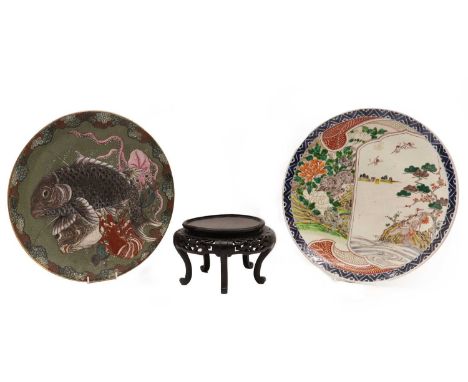 Two Japanese chargers,20th century, comprising: one covered by a green crackled glaze, painted with twin fish, a lobster and 