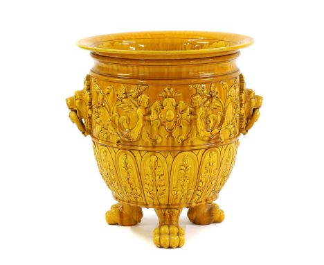 A Burmantofts style yellow glazed pottery jardiniere,late 19th to early 20th century, with relief floral decoration featuring