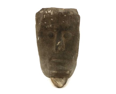 A carved limestone head,in the Celtic style,12cm wide9cm deep22cm longCondition ReportWear, weathering and degradation throug