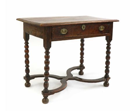 An oak side table, late 17th/ early 18th century and later, the moulded rectangular top above a single frieze drawer, raised 