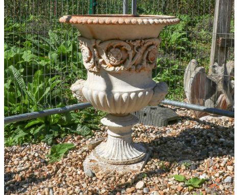 A cast iron Campana garden urn,probably 19th century, with twin double-mask handles, complete with detached plinth,58cm diame