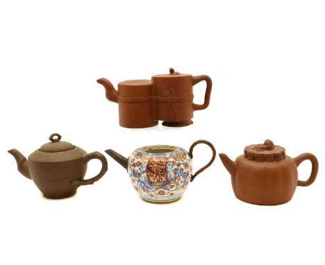 A Chinese blue and white clobbered teapot, Kangxi (1662-1722), decorated with floral scrolls, with a metal spout and handle, 