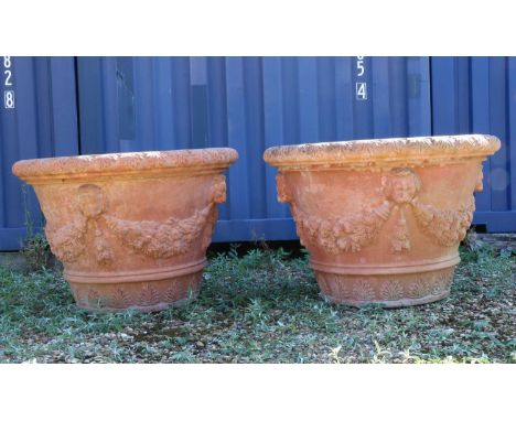A large pair of Italian terracotta garden urns,relief moulded with lion mask swags,113cm diameter80cm highCondition ReportMin