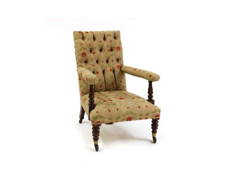 A Victorian mahogany upholstered armchair,with crewelwork style upholstered, raised on bobbin turned front supports, the fron