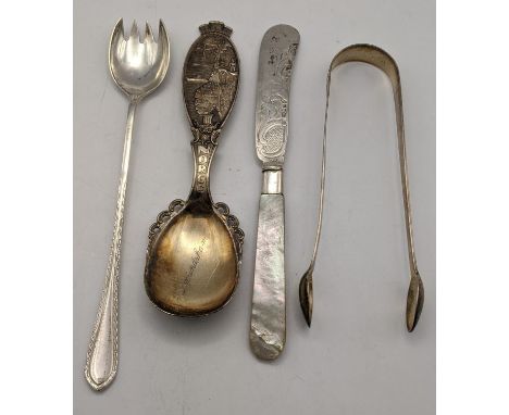Silver flatware to include an elongated fork, sugar tongs, a Norwegian spoon 108g, and a mother of pearl handled butter knife