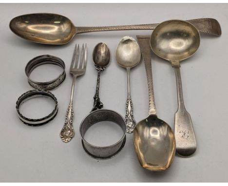 Silver to include a bright cut engraved basting and serving spoon, three napkin rings a ladle and three spoonLocation: 