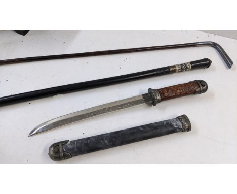 Two walking sticks to include one with a white metal engraved handle with a bamboo shaft, together with a reproduction dagger