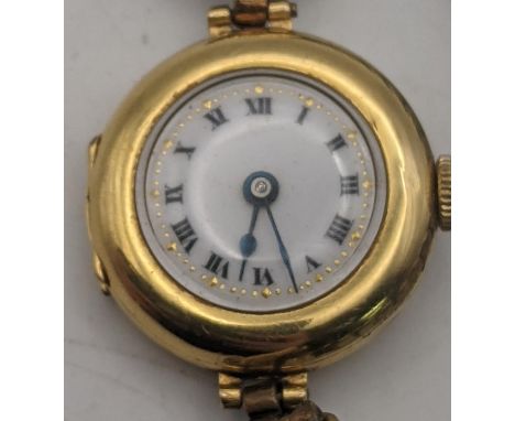 An early 20th century 18ct gold ladies manual wind wristwatch with a later expanding strap, total weight 22.4g Location: 