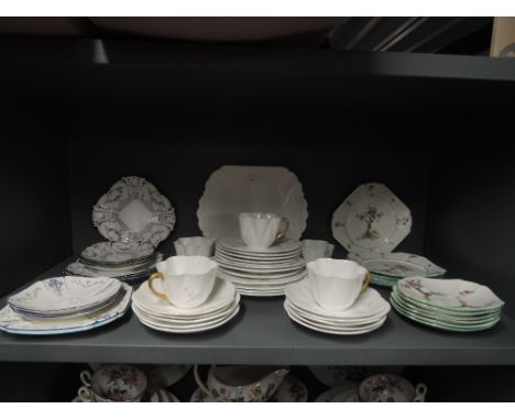 A selection of fine china by Shelley including tea cups saucers cake plates some hand decorated and art deco designs also ear