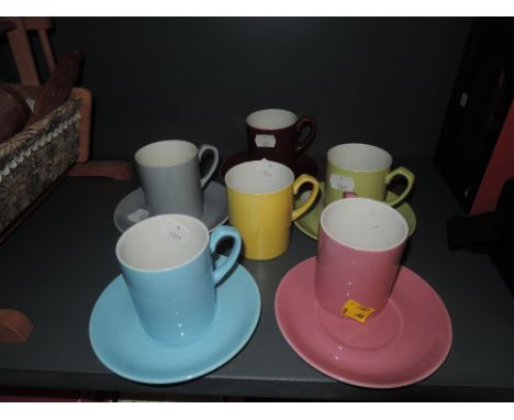A selection of harlequin cups and saucers by Woods Ware 