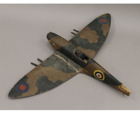 A mid-20th century wooden model of a Spitfire. 