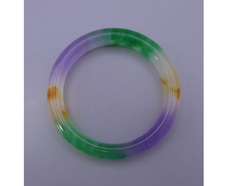 A multi-coloured jade bangle. 7.5 cm exterior diameter.