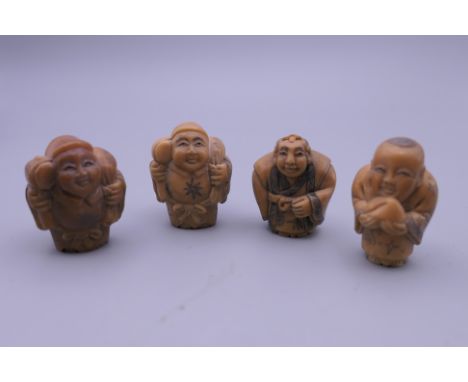 Four carved bone netsuke. Each approximately 4 cm high.