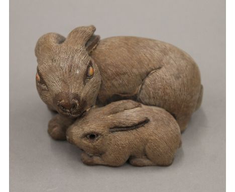 A Japanese carved wooden model of rabbits. 7.5 cm long.