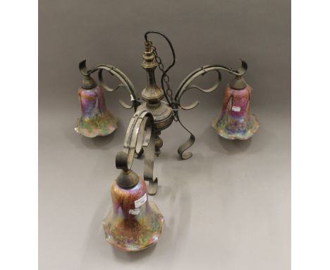 A brass and tinted glass three branch ceiling light. 43 cm high.