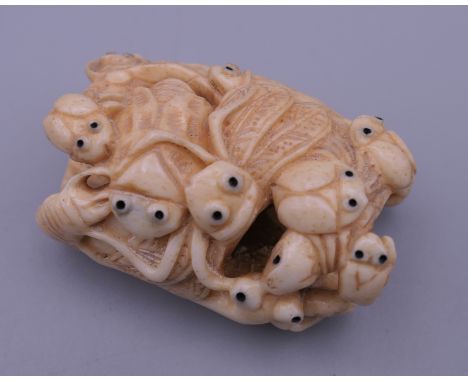 A carved bone netsuke formed as insects. 5 cm wide.