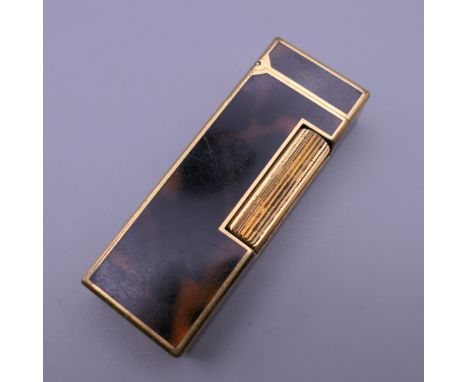 A Dunhill lighter. 6 cm high.