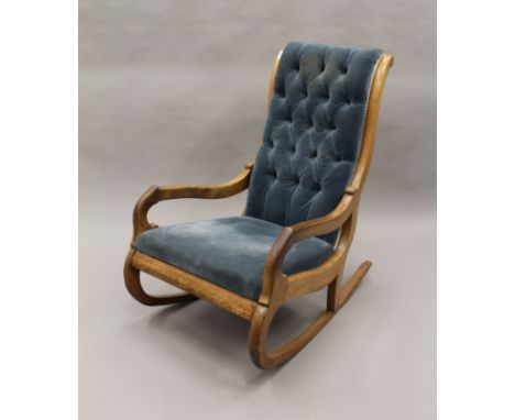 A Victorian mahogany framed button back rocking chair. 58.5 cm wide.