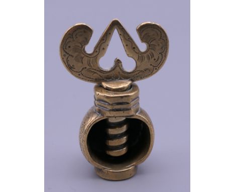 A Charles II period brass nutcracker with seal. 5 cm high when closed.