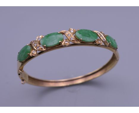 A gold jade and diamond bangle form bracelet. 5.5 cm wide. 11.9 grammes total weight.