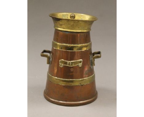 A brass and copper tea caddy formed as a milk churn. 19 cm high.