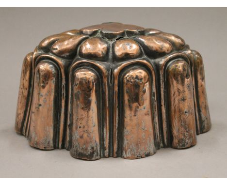 A 19th century copper jelly mould, inscribed R A Mess 1850. 19 cm long.