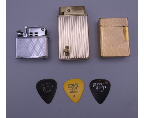 A vintage Dupont lighter and two others. The former 3.5 cm wide.