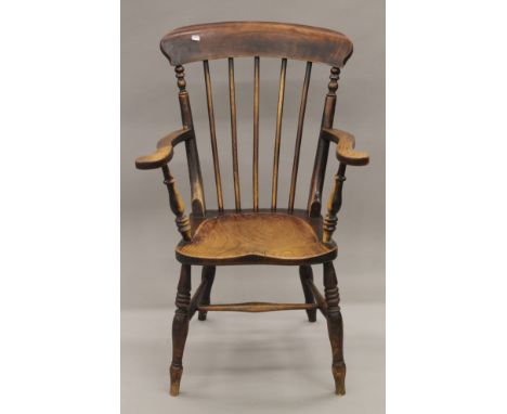 A Victorian elm seated stick back open armchair. 63.5 cm wide.