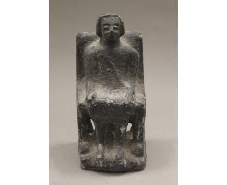 A model of a seated woman. 18 cm high.