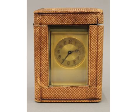 A 19th century brass carriage clock, housed in a travelling case. 15 cm high. 