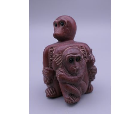 A carved wooden netsuke formed as monkeys. 5 cm high.